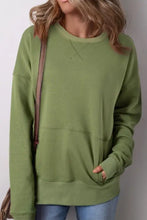 Olive green solid color round neck long sleeve sweatshirt with kangaroo pocket