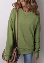Solid color round neck long sleeve sweatshirt in green with kangaroo pocket