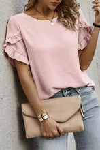 Beige faux leather envelope clutch with gold-tone zipper and hardware paired with a solid color ruffle trim short sleeve blouse