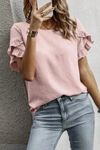Soft pink solid color short sleeve blouse with ruffle trim and lightweight fabric for a relaxed fit