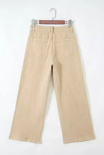 Beige solid color seamed wide leg cropped denim jeans with relaxed fit and classic back pockets shown from the back