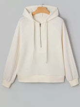 Cream-colored solid color textured sleeve patchwork half zip hoodie with ribbed cuffs and slightly stretchy material fabric