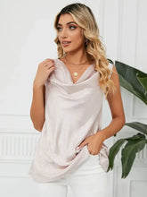 A blush pink solid cowl neck top with a sleeveless design and subtle shimmering texture for elegant wear