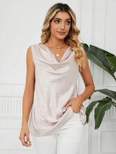 A solid cowl neck top in blush pink with a soft sleeveless design and subtle shimmering texture