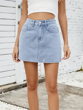 Light-wash solid mini denim skirt with classic five-pocket design and button closure in denim material