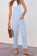 Spaghetti strap denim overalls in light blue with pockets and white tank top