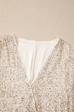 A shimmering gold sequin long sleeve bodysuit with deep v-neckline and delicate white inner lining