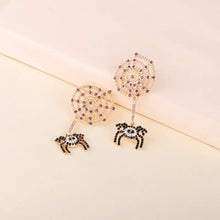 Gold spider rhinestone alloy earrings with purple crystal accents