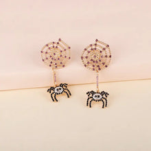 Gold-toned spider rhinestone alloy earrings with purple and black gems