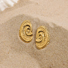 Spiral gold stud earrings in 18k gold-plated stainless steel with textured swirls