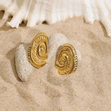 Spiral gold stud earrings, 18k gold-plated stainless steel on beach