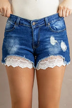 Spliced lace distressed denim shorts in blue with white trim