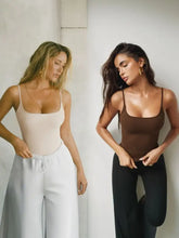 Two women modeling minimalist square neck piece cami bodysuits in soft beige and rich brown tones
