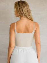 Beige sleeveless piece cami with thin straps and square neck in a two piece cami set for versatile layering