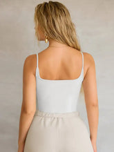 A white sleeveless square neck piece cami with thin straps in a lightweight fabric perfect for layering or casual wear