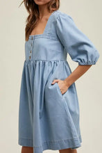 A light blue denim dress with puffed sleeves and square neck half design suitable for machine wash cold