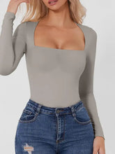 A sleek gray square neck long sleeve bodysuit with subtle ruching along the arms for a refined look