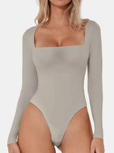 A sleek taupe long sleeve bodysuit with square neck long design and high-cut leg for a stylish fit