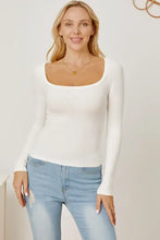 White square neck long sleeve top with light wash ripped jeans