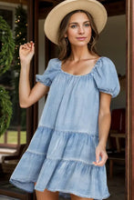 Light blue denim dress with square neck puff sleeves and tiered skirt made for machine wash cold care