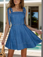 Blue denim dress with square neck tie shoulders and flared skirt made from machine wash cold fabric