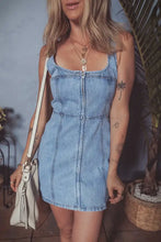 Light blue denim dress with square neck wide straps and front zipper in a mini denim dress style