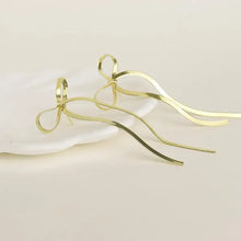 Gold stainless steel bow earrings with long wavy chains and bow bar design
