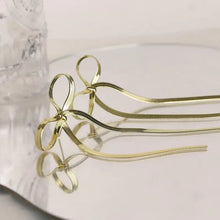 Stainless steel bow earrings with long wavy snake chains