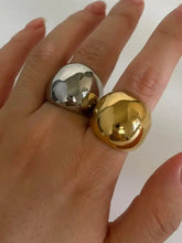 Shiny stainless steel bubble shape ring on finger in gold and silver