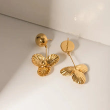 Stainless steel flower dangle earrings with gold-toned spherical stud and three-petal drop