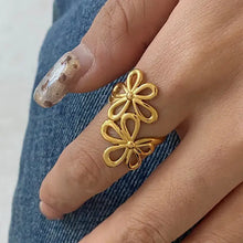 18k gold-plated stainless steel flower ring on glittery manicured finger