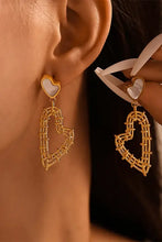 Gold-toned stainless steel heart earrings with mother-of-pearl studs