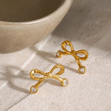 Gold steel inlaid zircon bow earrings with heart stones