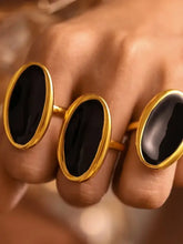 Three 18k gold-plated steel oil drip elliptical open rings with oval black enamel settings