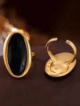 Two 18k gold-plated steel oil drip elliptical open rings with black stone