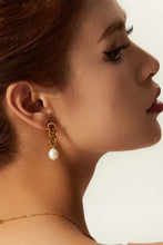 18k gold-plated stainless steel pearl earrings with gold chain and pearl drop on woman’s ear