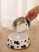 Stainless steel pet bowl with black cow print and shiny inner lining