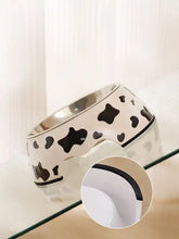 White stainless steel pet bowl with black cow print pattern