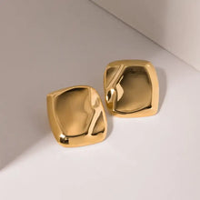 Shiny stainless steel square stud earrings with gold-toned, melted surface