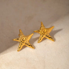 Pair of stainless steel star shape earrings with gold starfish spiral design