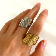 Silver and gold stainless steel textured wave rings on fingers
