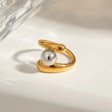 Stainless steel twisted ring with gold tone, silver sphere, and gemstone accent