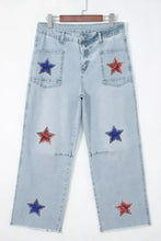 Light-wash denim cropped jeans featuring red and blue star embellishments on front pockets and legs