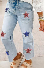 Light-wash denim cropped jeans with red and blue star embellishments made of sequins on front sides