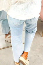 Light-wash denim cropped jeans with star embellishments straight-leg cut and frayed hems