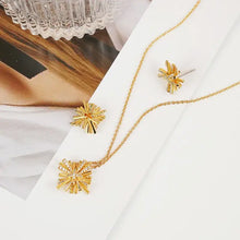 Starburst gold-plated necklace set with starburst pendant and stud earrings