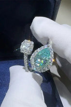 Sterling silver bypass ring with pear teal moissanite accents