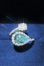 Sterling silver bypass ring with pear teal diamond and cluster accents