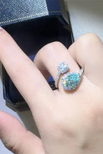 Sterling silver bypass ring with teal moissanite pear center and accents