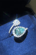 Sterling silver bypass ring with pear teal diamond accents